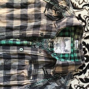 Plaid shirt, sleeves roll up.