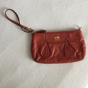 Burnt orange Coach oversized leather wristlet