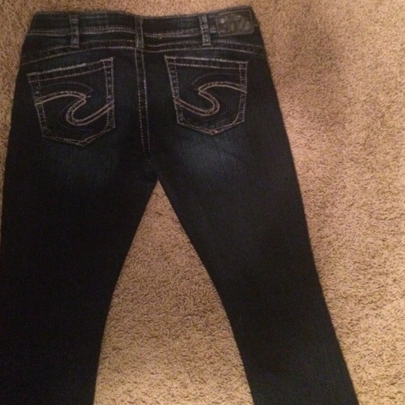 A pair of dark blue silver jeans