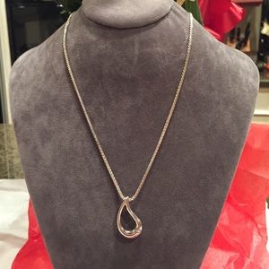 Silver tear drop with a single stone.