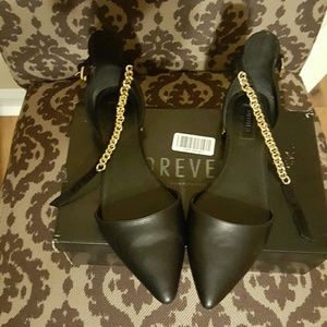 Black flats w gold accent ankle strap and heel.