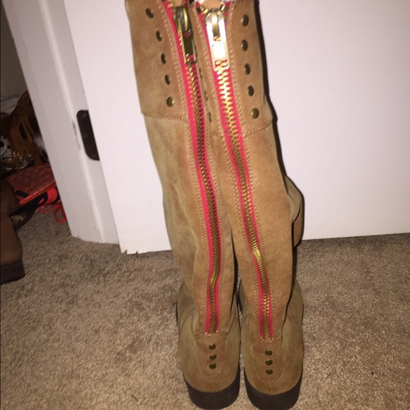 light brown boots go up higher than the calf