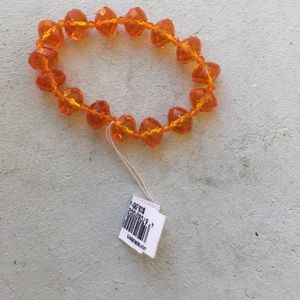 An orange bracelet/ new