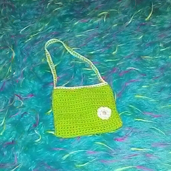 Green and white knitted little purse with flower