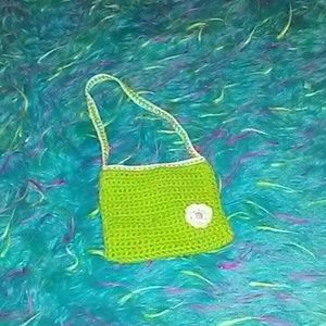 Green and white knitted little purse with flower
