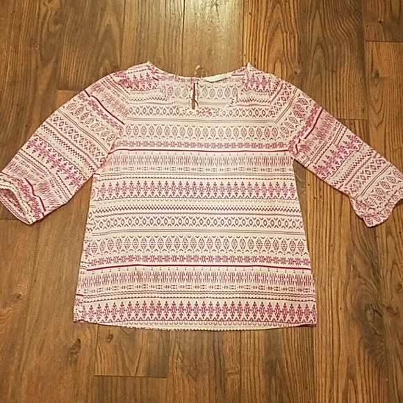 Pink and white patterned blouse.