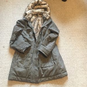 A warm hooded fur lined green winter coat