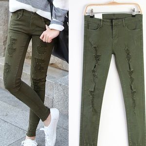 Distressed green skinnies