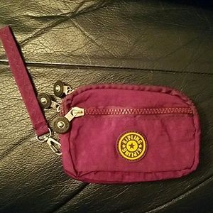 Purple and yellow kipling wristlet