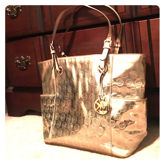 Michael Kors gold hand bag.