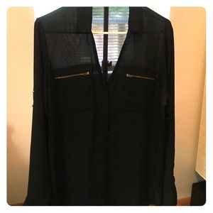 Black blouse with gold zipper pockets and buttons