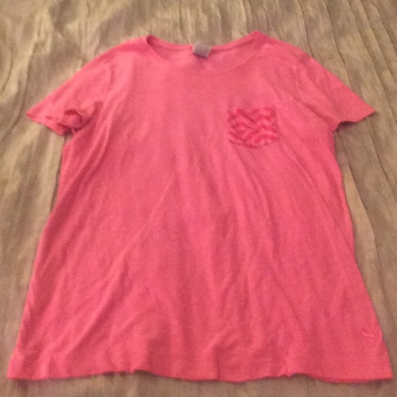 pink t-shirt with chevron pocket in the top corner