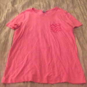 pink t-shirt with chevron pocket in the top corner