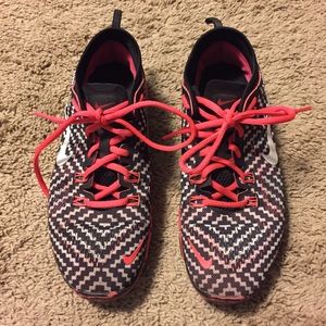 Coral and black Nike shoes