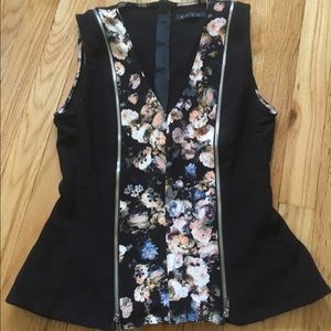 Sleeveless, v-neck peplum top with zipper accents.