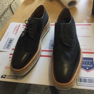 DESIGNER
PRADA
Rubberised-Leather Wingtip Brogues