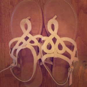 Tan sandals with strap.