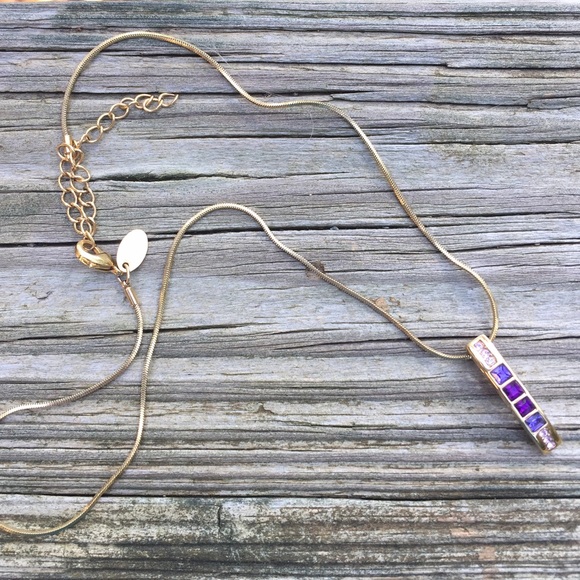 A gold and purple necklace💜