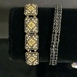 2 strechtchy bracelets, one is black the other is