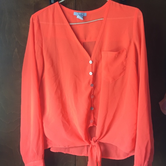 Neon orange button up. Tie at bottom.