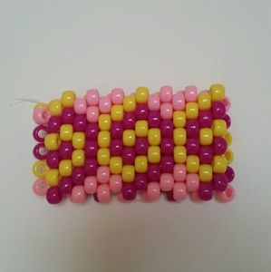 A pink swirl kandi cuff