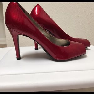 Open toe heels in candy apple red.