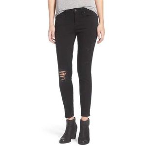 Distressed black skinny jeans