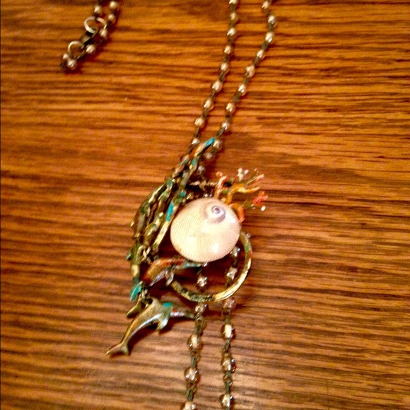 Dolphins jumping over sea shell - Picture 1 of 1