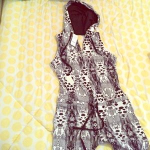 Black/white Bebe jumpsuit. Cut out back with hood