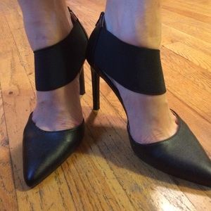 Black pointed toe pumps with elastic details