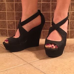 Platform peep toe wedges with cross front straps.