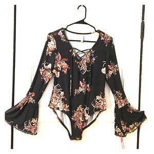 Brand new never word Xhiliration floral body suit