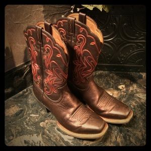 Bronze Ariat Legend boots with red stitching.