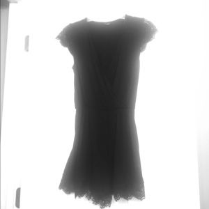 Black romper (shorts) with lace cap sleeves.