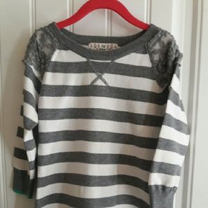 Striped sweater with green trim.