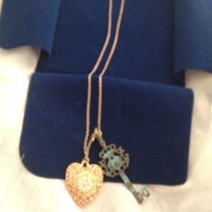 Gold tone chain necklace with heart and key