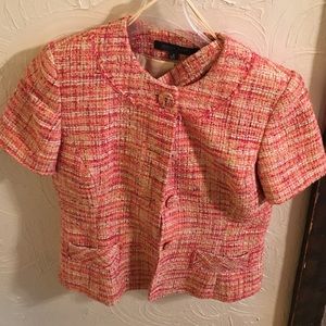 A short sleeved tweed suit with lining.