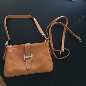 Handbag with cross body shoulder strap