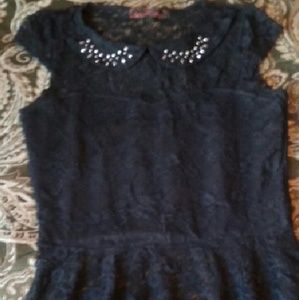 Black shirt with rhinestones.