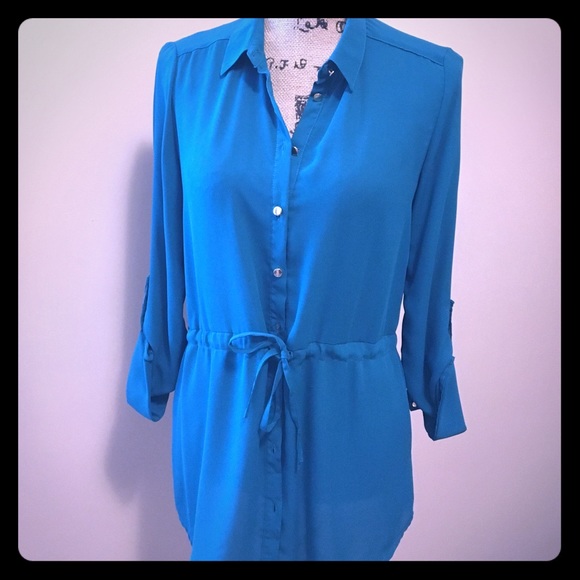 Teal/green blouse with gold buttons