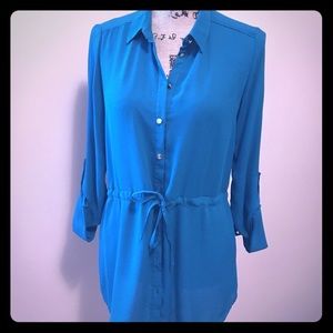 Teal/green blouse with gold buttons