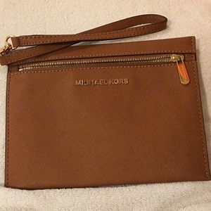 2 leather Michael Kors clutched with wristlets.