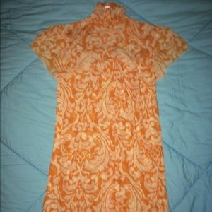 Orange and white sheer top.