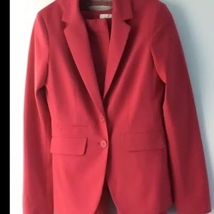 Dark pink/coral suit.