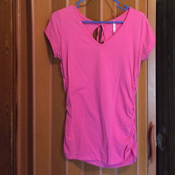 Pink top gathered on sides, long fitting.