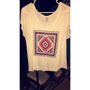 White tee with tribal design.