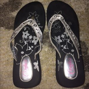 Black and silver flip flops
