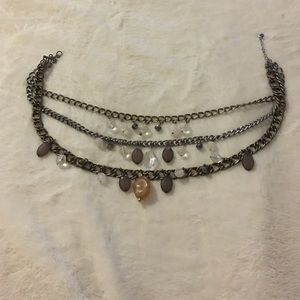 Fashion jewelry three chain and stone necklace.
