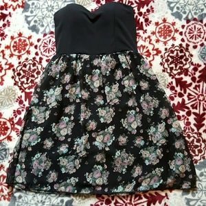 Black strapless dress with flowered skirt.