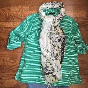 Kelly green and white polka dot blouse.